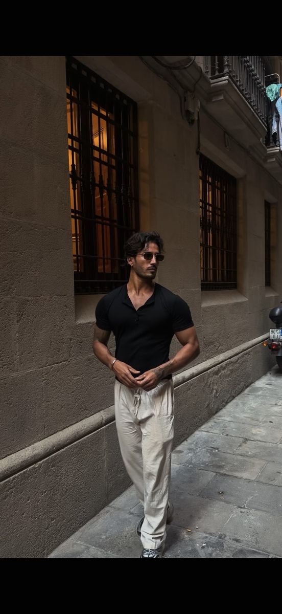 Franco in a black knit polo at night